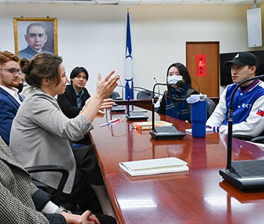 Students talking in a boardroom