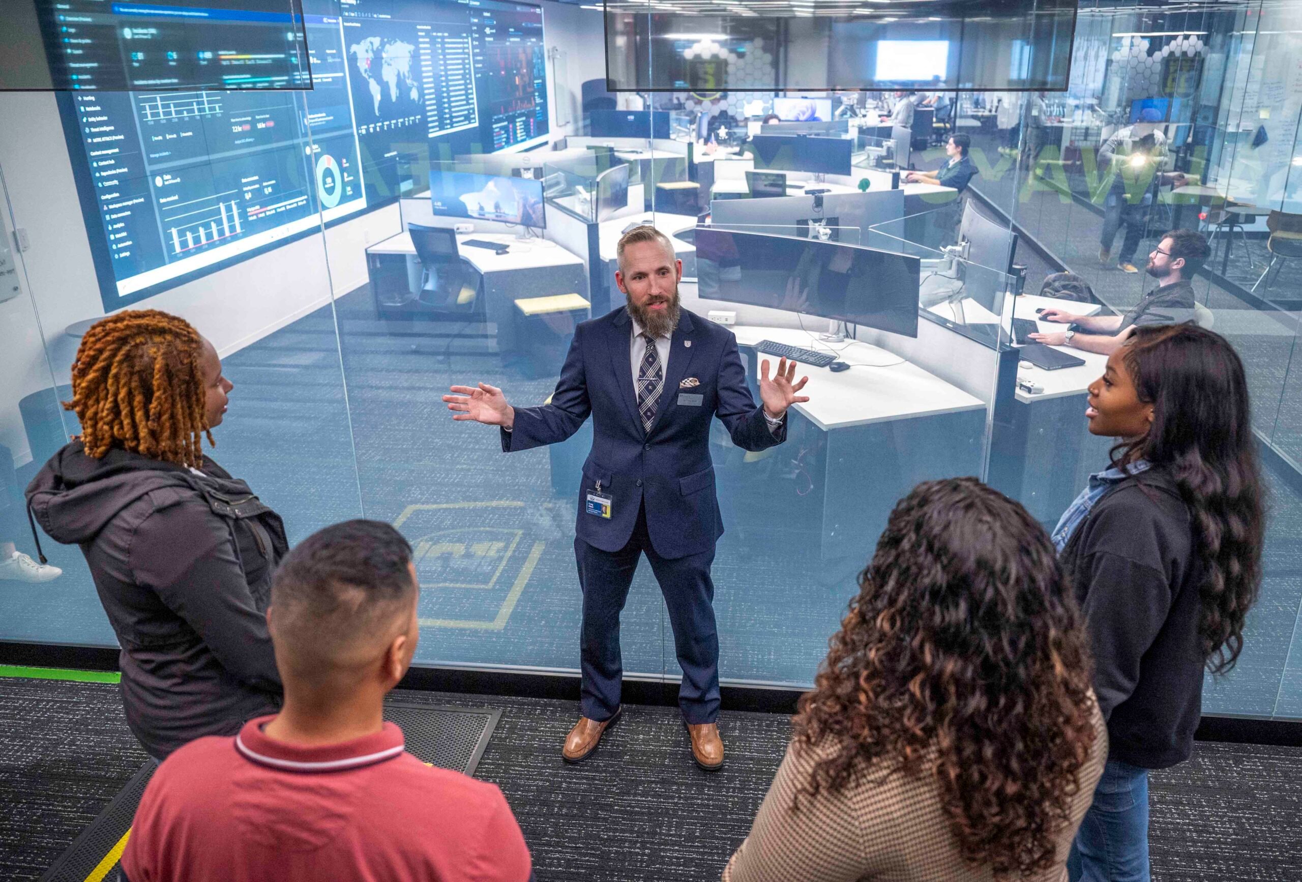 Dr. Craig Albert, middle, leads a group of students on tour of Augusta University’s Security Operations Center at the Georgia Cyber Center in Augusta, GA