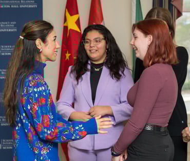 Three people standing and talking