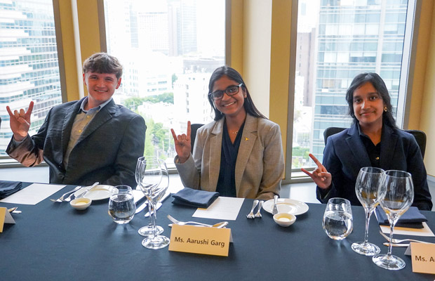 Three students sitting at a meeting table